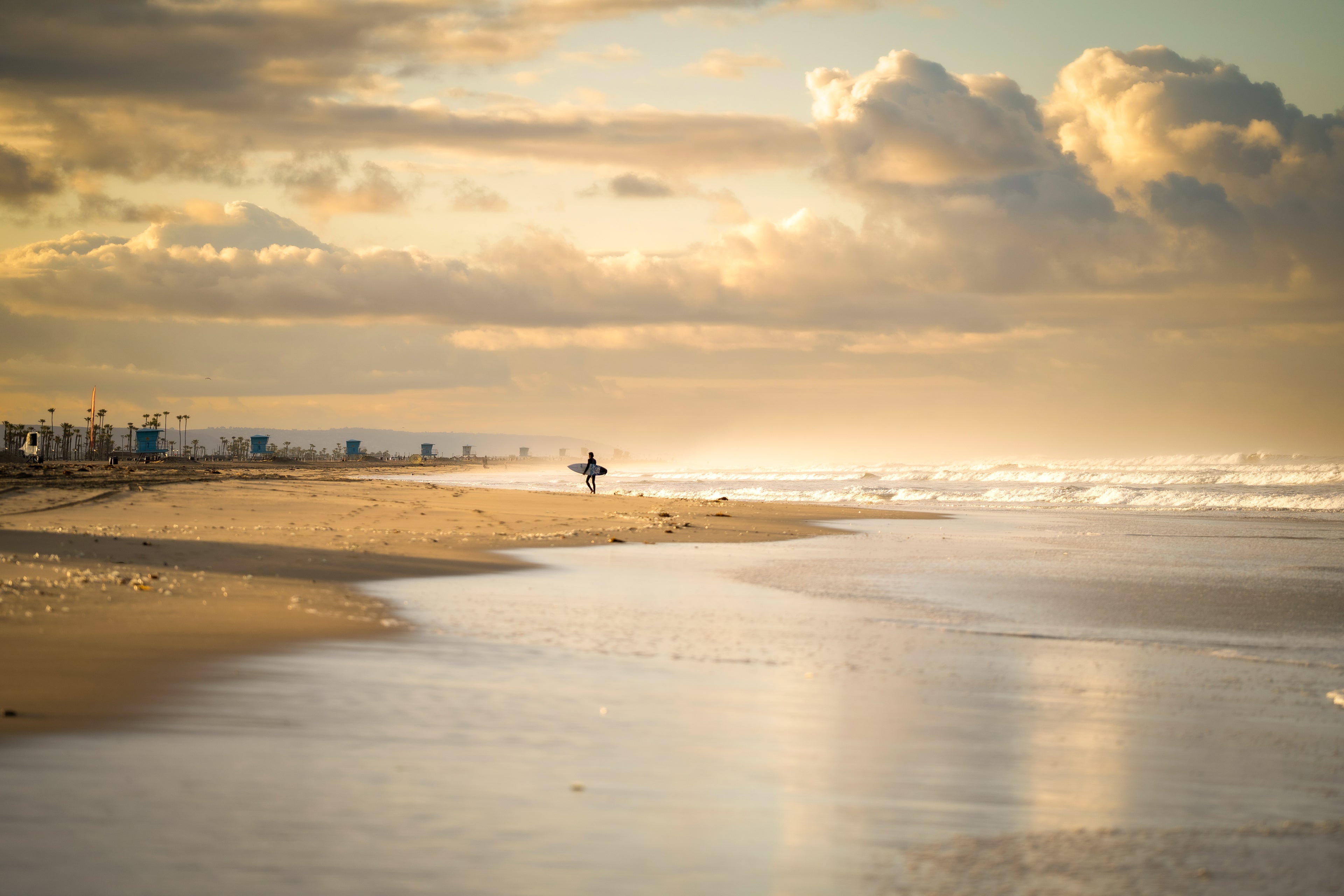 Lone Surfer Leaving the Water at Huntington Beach Pier