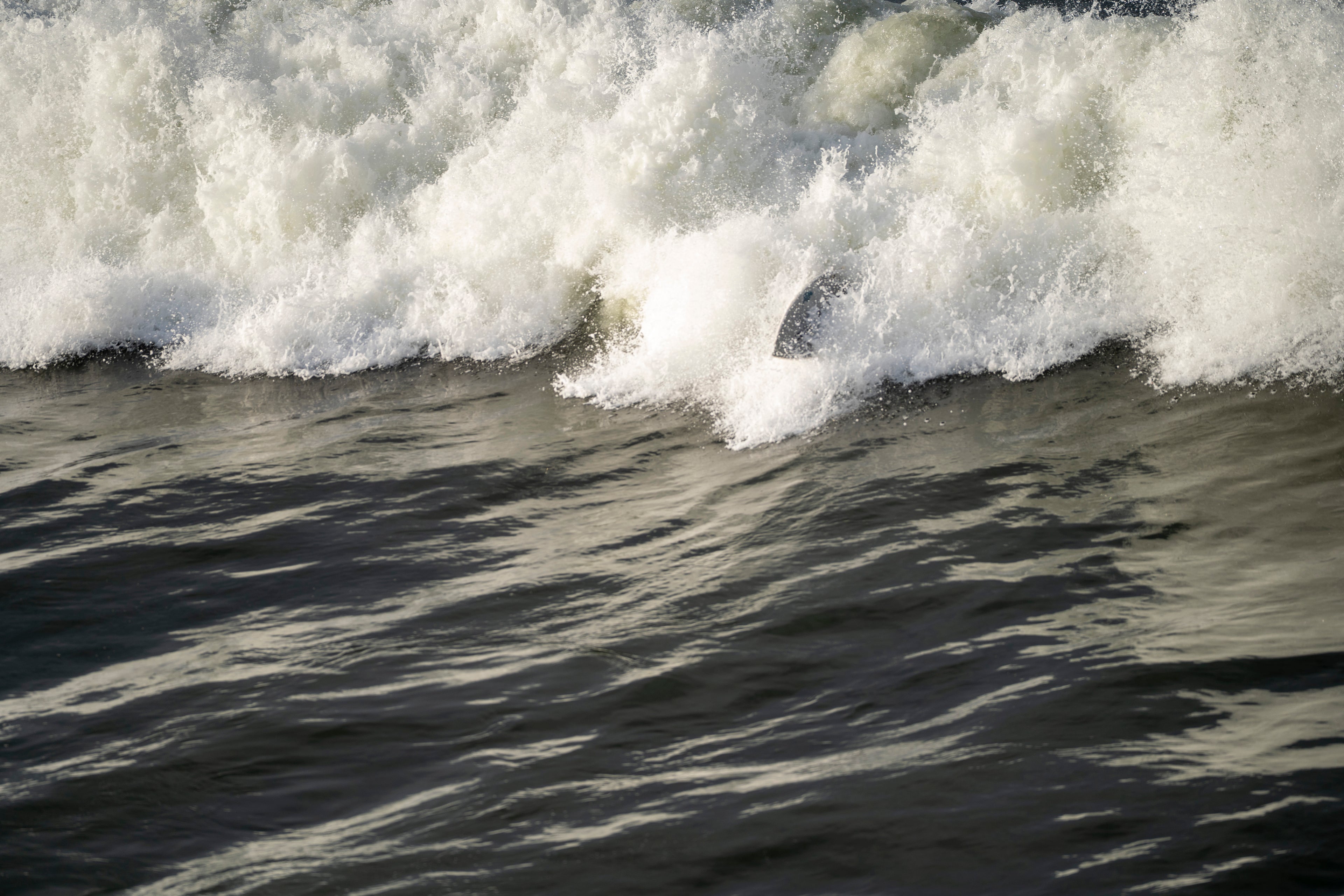 ABSTRACT WAVE WITH SURFBOARD IN THE WHITEWASH